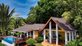 Relax At This Hillside Retreat That Overlooks The Lush Forest And The Caribbean,